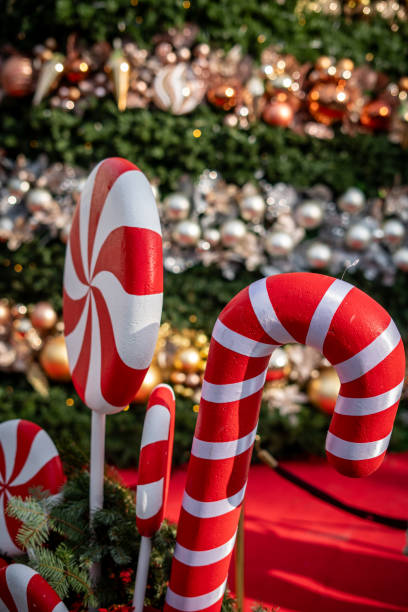 istock christmas candy on foreground christmas tree is background vertical christmas still 2189878378