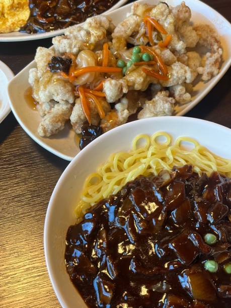 Jajangmyeon, a popular Korean dish featuring thick wheat noodles topped with a rich, savory black bean sauce made from chunjang, diced pork, and vegetables. Hearty and flavorful, it’s a comforting, satisfying meal.