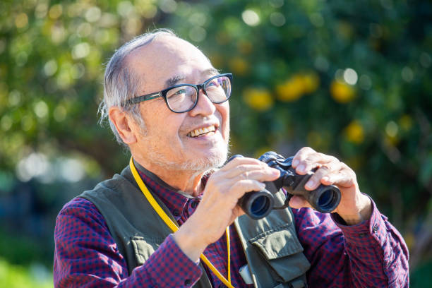 istock Bird watching, outdoor activities, senior Japanese man holding binoculars 2189887771
