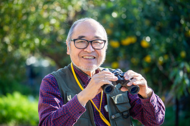 istock Bird watching, outdoor activities, senior Japanese man holding binoculars 2189887772