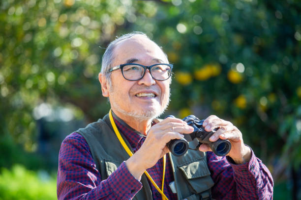 istock Bird watching, outdoor activities, senior Japanese man holding binoculars 2189887774