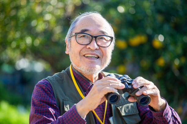 istock Bird watching, outdoor activities, senior Japanese man holding binoculars 2189887776