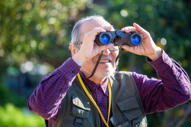 istock Bird watching, outdoor activities, senior Japanese man holding binoculars 2189887780