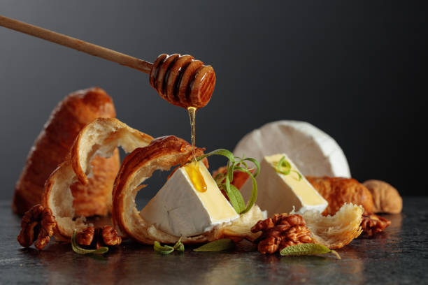 istock Camembert cream cheese with honey, croissants, and walnuts. 2189891230