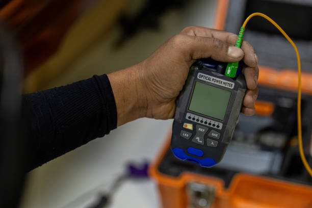 istock Optical fiber installation with Digital Fiber Optical Fusion Splicing machine. High precision fiber optic cleaver is being used during a fiber optic wire install at House. Welding of optical fibers. 2189892710