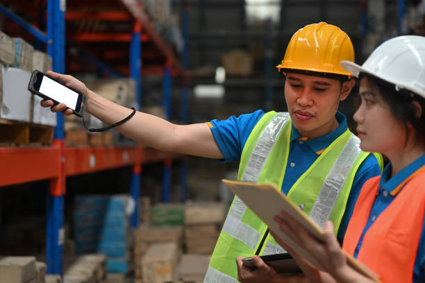 istock Two warehouse workers do stocktaking in a storehouse, Close-up, a warehouse management system, supply chain, and logistic concept 2189895016