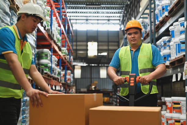 istock Distribution warehouse workers moving boxes on a hand truck loaded in Warehouse industrial stock storage 2189895754