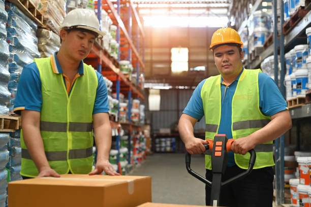 istock Distribution warehouse workers moving boxes on a hand truck loaded in Warehouse industrial stock storage 2189895981