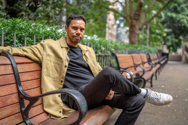 istock Portrait of Young Aboriginal Man Relaxing on a Park Bench 2189897329