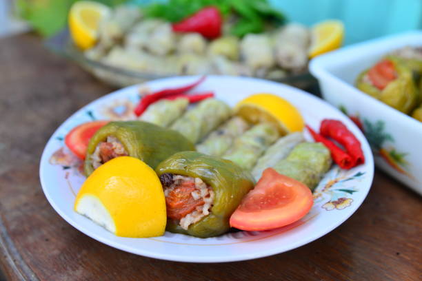 Stuffed green bell peppers (biber dolman) and cabbage rolls on a tableCabbage rolls (lahana sarmasi) is Turkish traditional food,a boiled cabbage leaf that is formed into a roll with a stuffing of rice