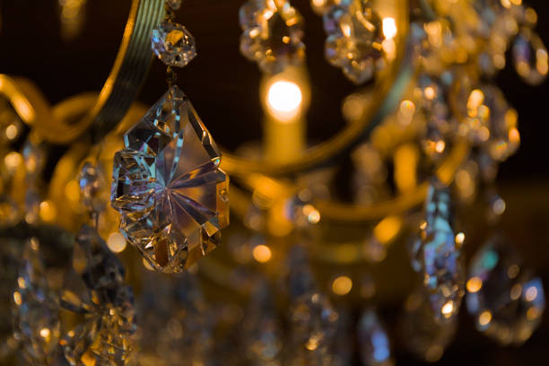 A sparkling golden crystal chandelier hangs elegantly from the ceiling.
