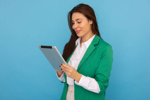 istock Smiling Latina professional scrolling on a tablet 2189897850