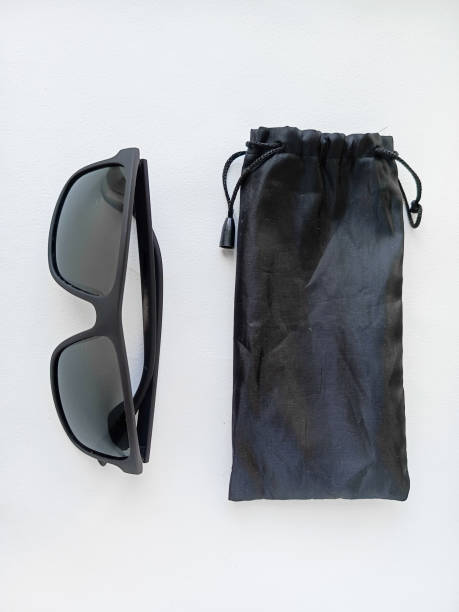 istock Sunglasses and a case for storing glasses on a white table. 2189897876