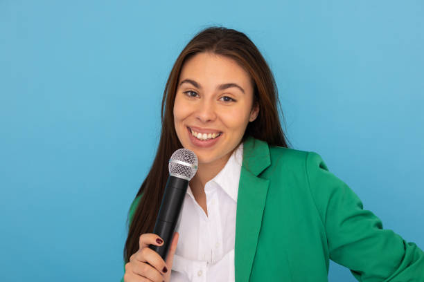 istock Confident young Latina woman holding a microphone 2189898866