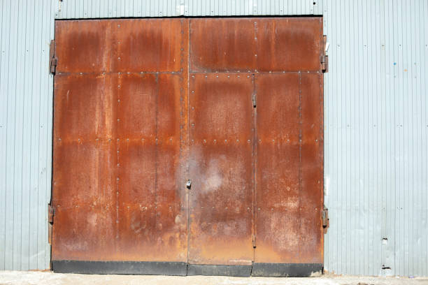istock Rusty gates. More of gate to warehouse. Old wall. 2189900213