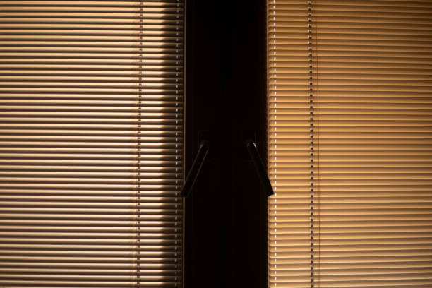 istock Blinds on the window. Light through the blinds. Window in the room. 2189902874