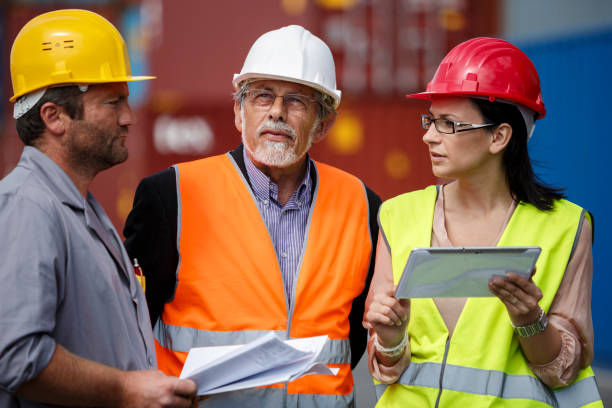 istock Logistics team discussing stock management and operations at a busy cargo dock, with a tablet and documents in hand 2189903586