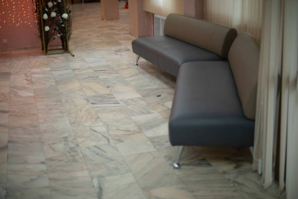 Soft sofas in interior. Ottomans for relaxation. Details of room. Furniture in building.