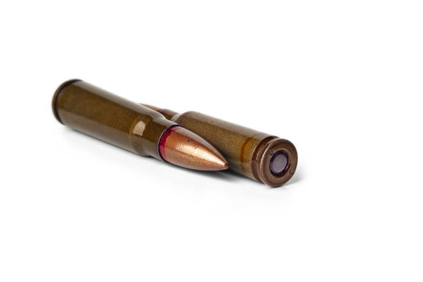 istock Two old bullets for automatic rifles of 5.45 and 7.62 caliber on a white. Selective focus 2189904620