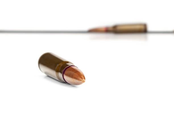 Old bullet for an automatic rifle 7.62 on a white background. Selective focus.