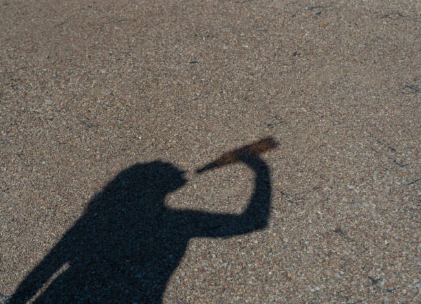 istock Man Drinking Water Silhouette, Drinking from Bottle Shadow in Bright Hot Sun, Heatwave Prevention 2189905287