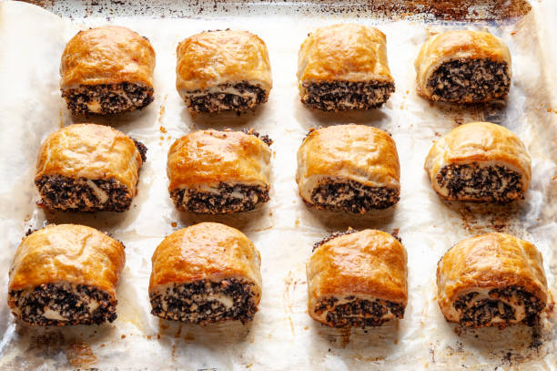 istock Crispy freshly baked cookies with poppy seeds on a baking tray. 2189906350