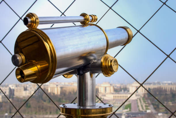 Telescope viewer and city skyline at daytime (against the background of very beautiful clouds). Paris, France.