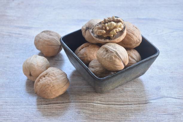 istock baked crispy walnut peel out arranging in cup 2189910401