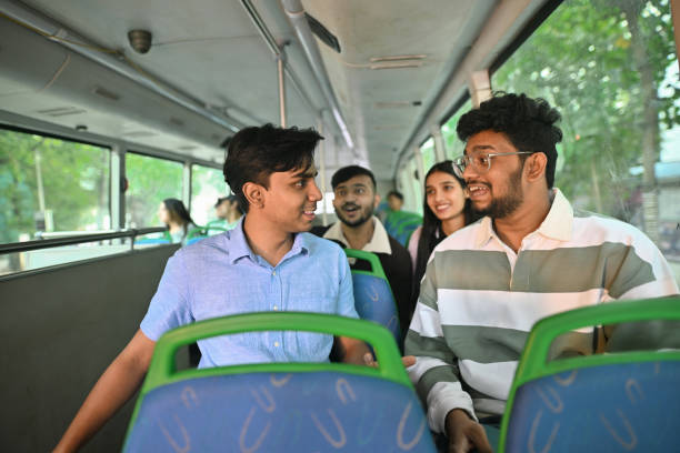 istock Group of young college students engaged in conversation on a bus 2189910841