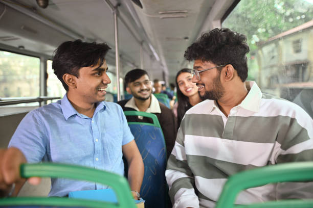 istock Group of young college students engaged in conversation on a bus 2189910845