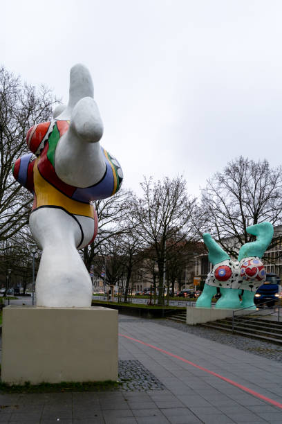 Hanover, Lower Saxony, Germany - December 12, 2024: Two colorful sculptures by Niki de Saint Phalle stand on a walkway in Hanover, Germany. The sculptures are part of the \