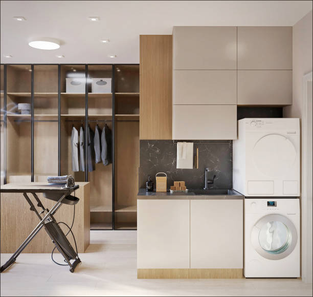 istock 3D render. Interior design of a dressing room with closed cabinets, ironing board, washer and dryer, desk and lamps. 2189912243
