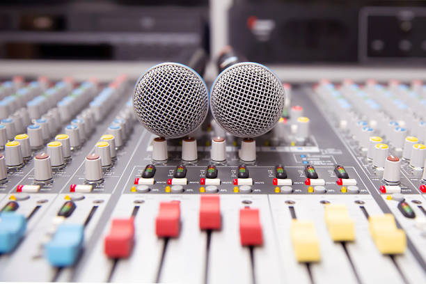 Microphone on the sound mixer in the studio for recording, editing, and Sound system control concept.