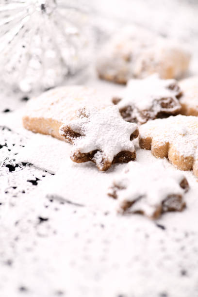Christmas cookies (cinnamon stars) on bright background. Soft focus. Close up
