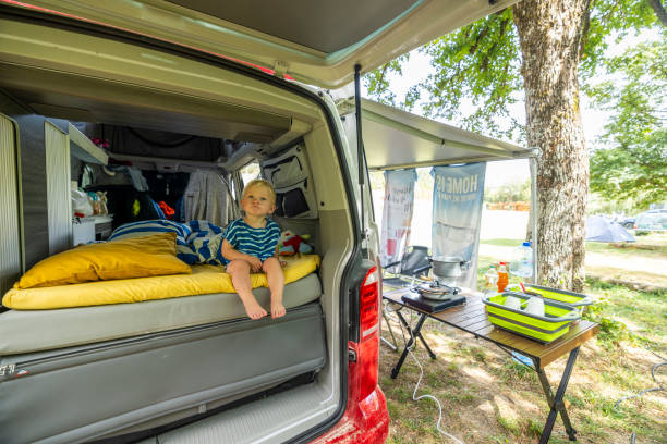 istock Curious Little Boy in Camper Van with Outdoor Cooking Setup 2189921637