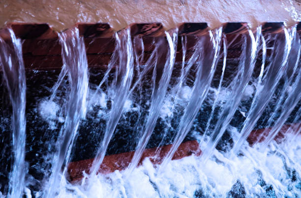 istock Water cascading over an artfully designed stone surface in a serene environment during the day 2189922290