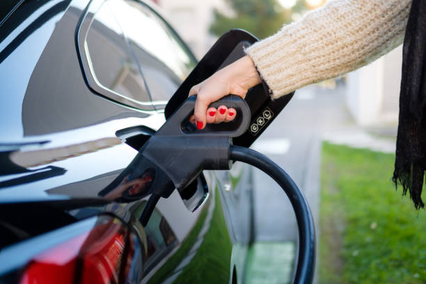 istock 40 year old woman charging electric car 2189923370
