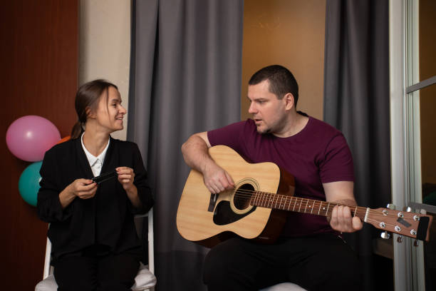 istock Two friends playing music together, practicing their musical instruments, embracing teamwork and creativity, sharing a passion for music. 2189924631