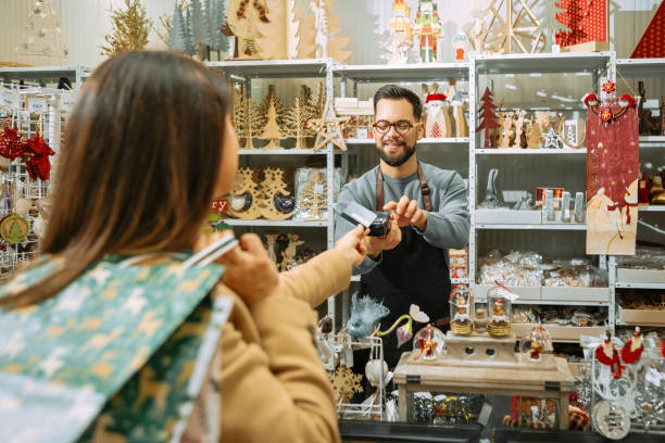 istock Woman Gets Help Picking Holiday Gifts 2189926411