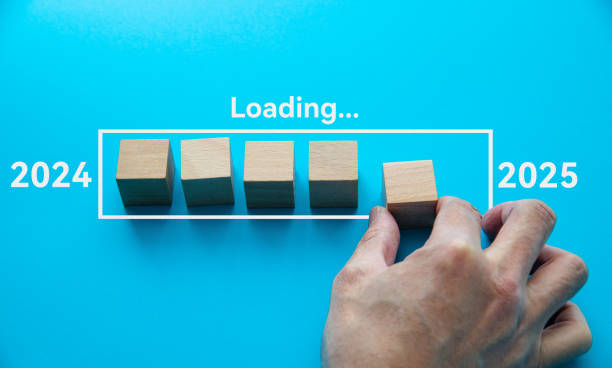 istock Loading new year 2025 with hand putting wood cube in progress bar 2189929048
