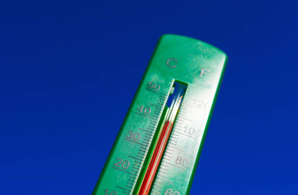 Thermometer for measuring outdoor air temperature. Meteorological device for observing and measuring the weather. Weather forecast. Thermometer on blue sky background. Hot weather, drought in summer.