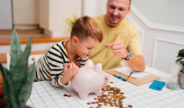 istock Father and son piggy  bank 2189932283