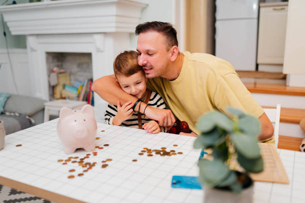 istock Father and son piggy  bank 2189932303