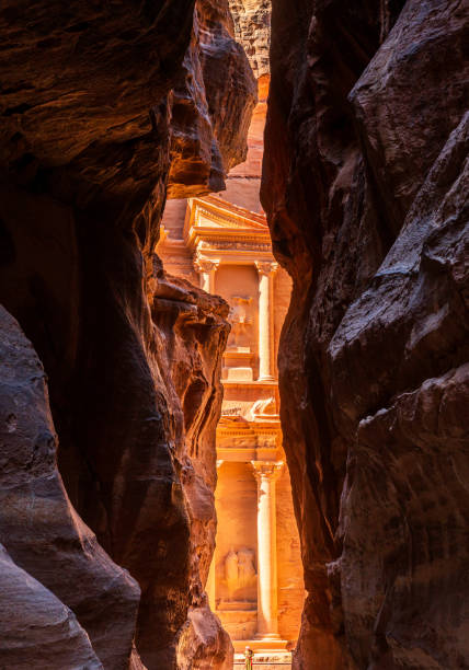 istock Petra Treasury building facade seen through narrow gorge 2189936249
