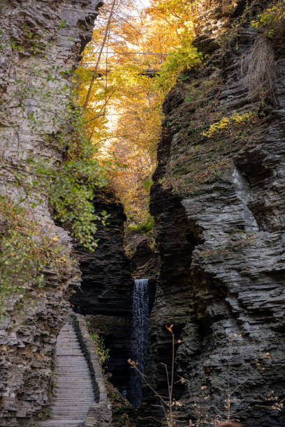 istock Stunning waterfall cascading through rocky cliffs surrounded by vibrant autumn foliage in in Watkins Glen State Park 2189938227