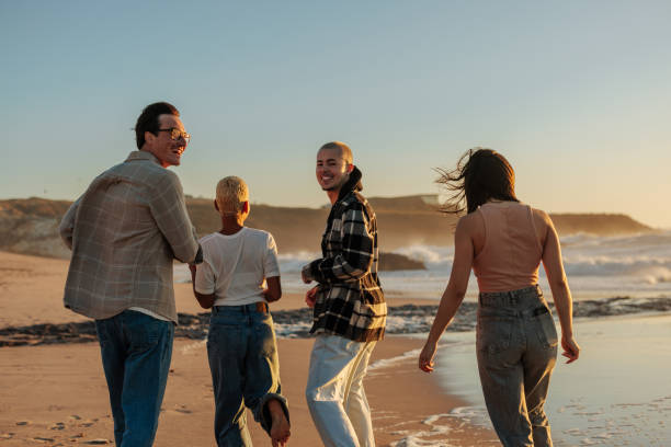 istock Friends walking on the beach at sunset, enjoying summer vacation 2189938949