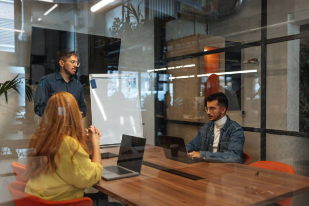istock Business team collaborating on project in modern office meeting room 2189939733
