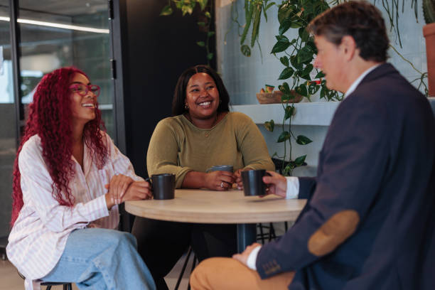 istock Diverse business team enjoying coffee break in modern office 2189940539
