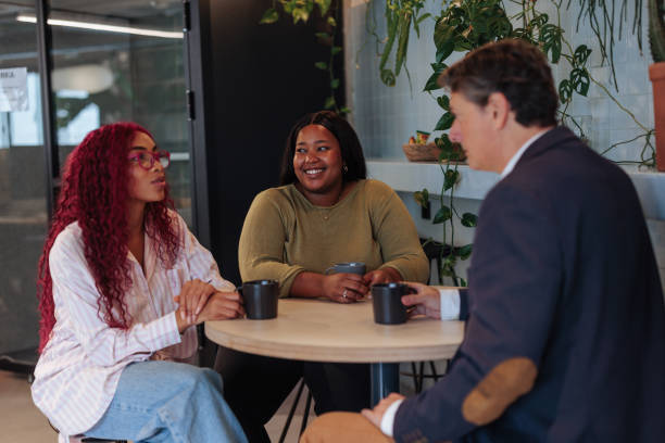 istock Diverse business team enjoying coffee break in modern office 2189940541