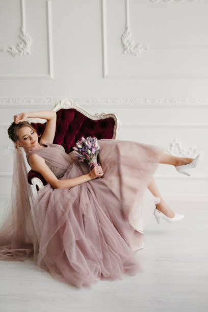 istock bride in lavender fluffy wedding dress in bright studio 2189940740